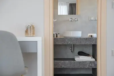 a bathroom with a sink and a counter at The Convo Syngrou Apartments in Athens