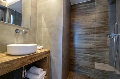 a bathroom with a sink and a shower at The Convo Syngrou Apartments in Athens