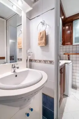 a white bathroom with a sink and a shower at Studio in the city center, Syntagma in Athens
