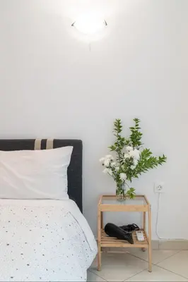 a bedroom with a bed and a table with a plant at Studio in the city center, Syntagma in Athens
