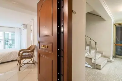 a room with a door and a bed and a staircase at Studio in the city center, Syntagma in Athens