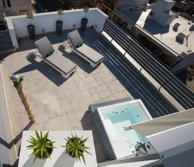 an overhead view of a swimming pool with chaise lounge chairs at Private Jacuzzi & Acropolis View - The Loft in Athens