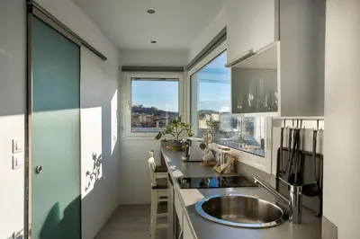 a kitchen with a sink and a large window at Private Jacuzzi & Acropolis View - The Loft in Athens