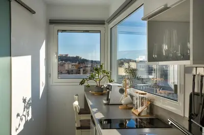 a kitchen with a counter and a window with a view at Private Jacuzzi & Acropolis View - The Loft in Athens