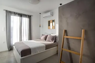a bedroom with a bed and a window at Private Jacuzzi & Acropolis View - The Loft in Athens