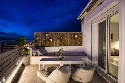 a balcony with a table and a view of the city at Private Jacuzzi & Acropolis View - The Loft in Athens