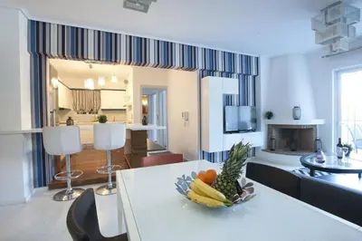 a living room with a table with a bowl of fruit at Glyfada A Modern minimal apartment in Athens