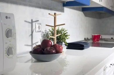 a bowl of apples on a counter in a kitchen at Glyfada A Modern minimal apartment in Athens