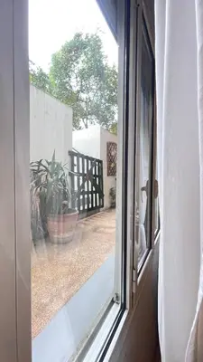 an open window with a potted plant on a patio at Cozy apartment ideally located city center and Megaron Moussikis metro station in Athens