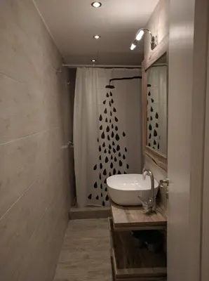 a bathroom with a sink and a shower at Cozy apartment ideally located city center and Megaron Moussikis metro station in Athens