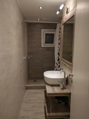 a bathroom with a sink and a shower at Cozy apartment ideally located city center and Megaron Moussikis metro station in Athens