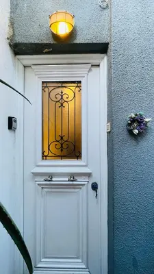 a white door with a window on top of it at Cozy apartment ideally located city center and Megaron Moussikis metro station in Athens