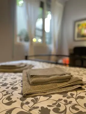 two towels are sitting on top of a bed at Cozy apartment ideally located city center and Megaron Moussikis metro station in Athens