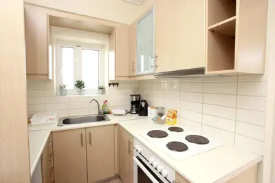 a kitchen with a sink and a stove top oven at Apartment near the Athens Airport, Spata in Spáta