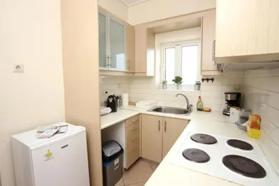 a small kitchen with a sink and a stove at Apartment near the Athens Airport, Spata in Spáta