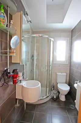 a bathroom with a shower and a sink and a toilet at Apartment near the Athens Airport, Spata in Spáta