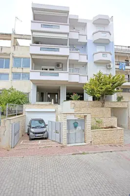 a car parked in a parking lot in front of a building at Apartment near the Athens Airport, Spata in Spáta