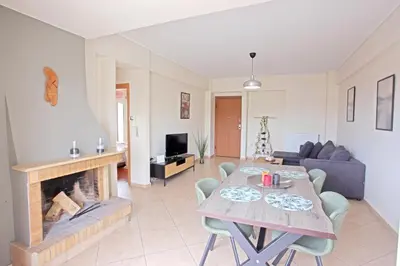 a living room with a table and a fireplace at Apartment near the Athens Airport, Spata in Spáta