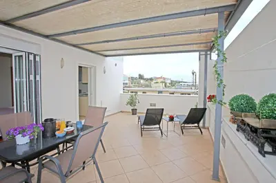 a patio with a table and chairs on a balcony at Apartment near the Athens Airport, Spata in Spáta