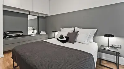 a bedroom with a large bed with white pillows at BAG- Boutique Apartment Grey - Hilton Area in Athens