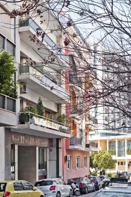 a bunch of cars parked in front of a building at BAG- Boutique Apartment Grey - Hilton Area in Athens