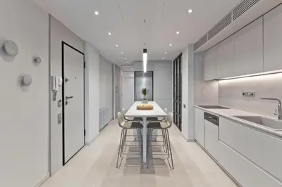 a kitchen with a white table and stools at BAG- Boutique Apartment Grey - Hilton Area in Athens