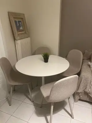 a white table and chairs with a plant on it at Central Halandri apartment near all hospitals in Athens