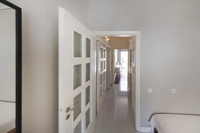 a hallway with white walls and a door at Central Halandri apartment near all hospitals in Athens