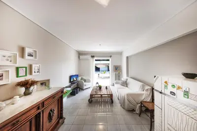 a living room with a couch and a table at Central Halandri apartment near all hospitals in Athens