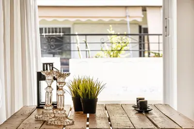 a table on a porch with a view of a balcony at Central Halandri apartment near all hospitals in Athens