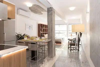 a kitchen with a table and chairs in a room at AM16 Suites Athens in Athens