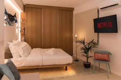 a bedroom with a bed and a sign on the wall at AM16 Suites Athens in Athens