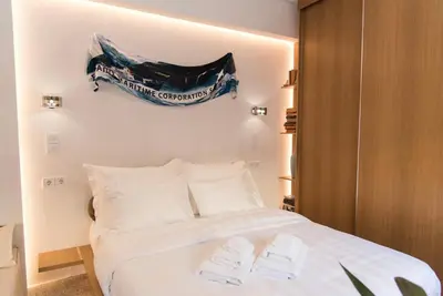 a bedroom with a bed with two towels on it at AM16 Suites Athens in Athens