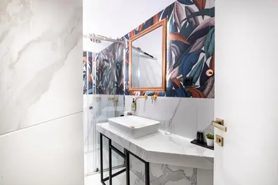a bathroom with a sink and a mirror at Belle Epoque Suites in Athens