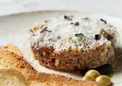 a piece of food on a plate with some chips at Belle Epoque Suites in Athens