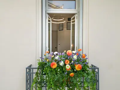 a window box with a flower arrangement on a balcony at Belle Epoque Suites in Athens