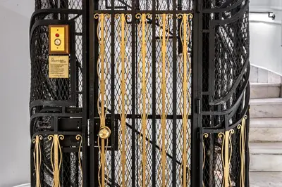 a black gate with gold chains on it at Belle Epoque Suites in Athens