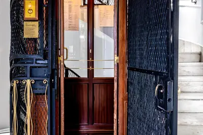 a door to a building with a sign on it at Belle Epoque Suites in Athens