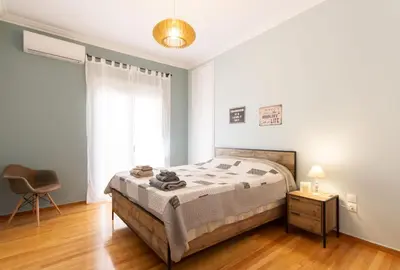 a bedroom with a bed and a chair in it at ATHENS Penthous at Center in Athens