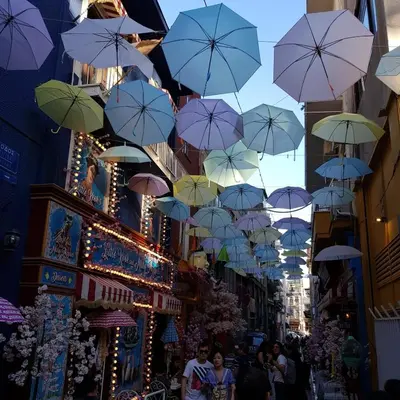 a bunch of umbrellas hanging over a street at ATHENS Penthous at Center in Athens