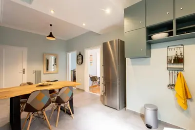 a kitchen with a wooden table and a refrigerator at ATHENS Penthous at Center in Athens