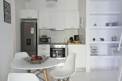 a kitchen with a table with a bowl of fruit on it at Victoria Sq., A cozy and stylish apartment in Athens