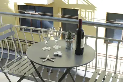 a table with a bottle of wine and two glasses at Victoria Sq., A cozy and stylish apartment in Athens
