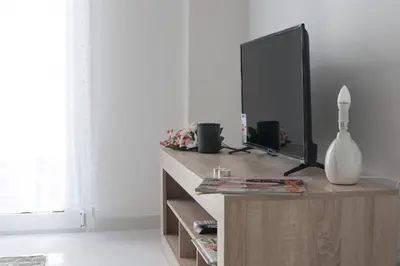 a living room with a television on a wooden dresser at Victoria Sq., A cozy and stylish apartment in Athens