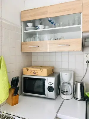 a kitchen counter with a microwave on top of it at Cozy Studio by seaside and tram in Athens