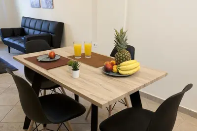 a wooden table with a plate of fruit on it at Comfortable apartment at the foot of the Odeon of Herodes Atticus in Athens