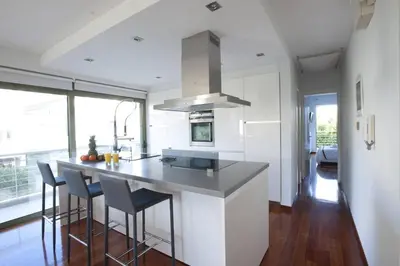 a kitchen with a island with bar stools at Voula, A modern, minimal and stylish, apartment in Athens