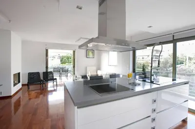 a kitchen with white cabinets and a counter top at Voula, A modern, minimal and stylish, apartment in Athens