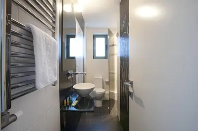 a bathroom with a toilet and a sink at Voula, A modern, minimal and stylish, apartment in Athens