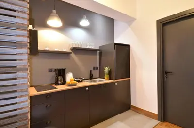 a kitchen with a sink and a counter at A modern rustic cosy apartment at the foot of Mount Lycabettus in Athens